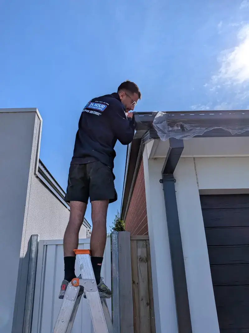 Roof plumber working on gutter in Balwyn